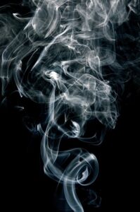 smoke rising against a black background